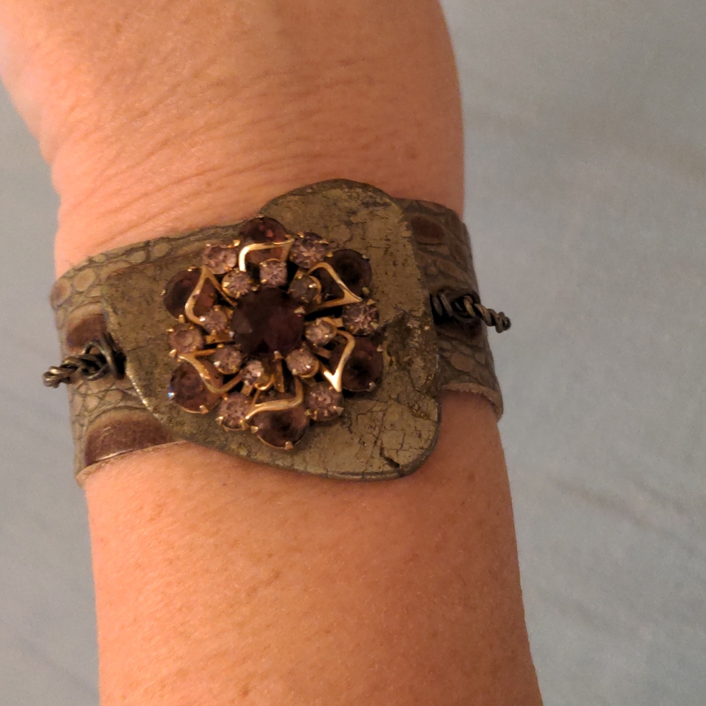 A Handmade leather and rhinestone bracelet.